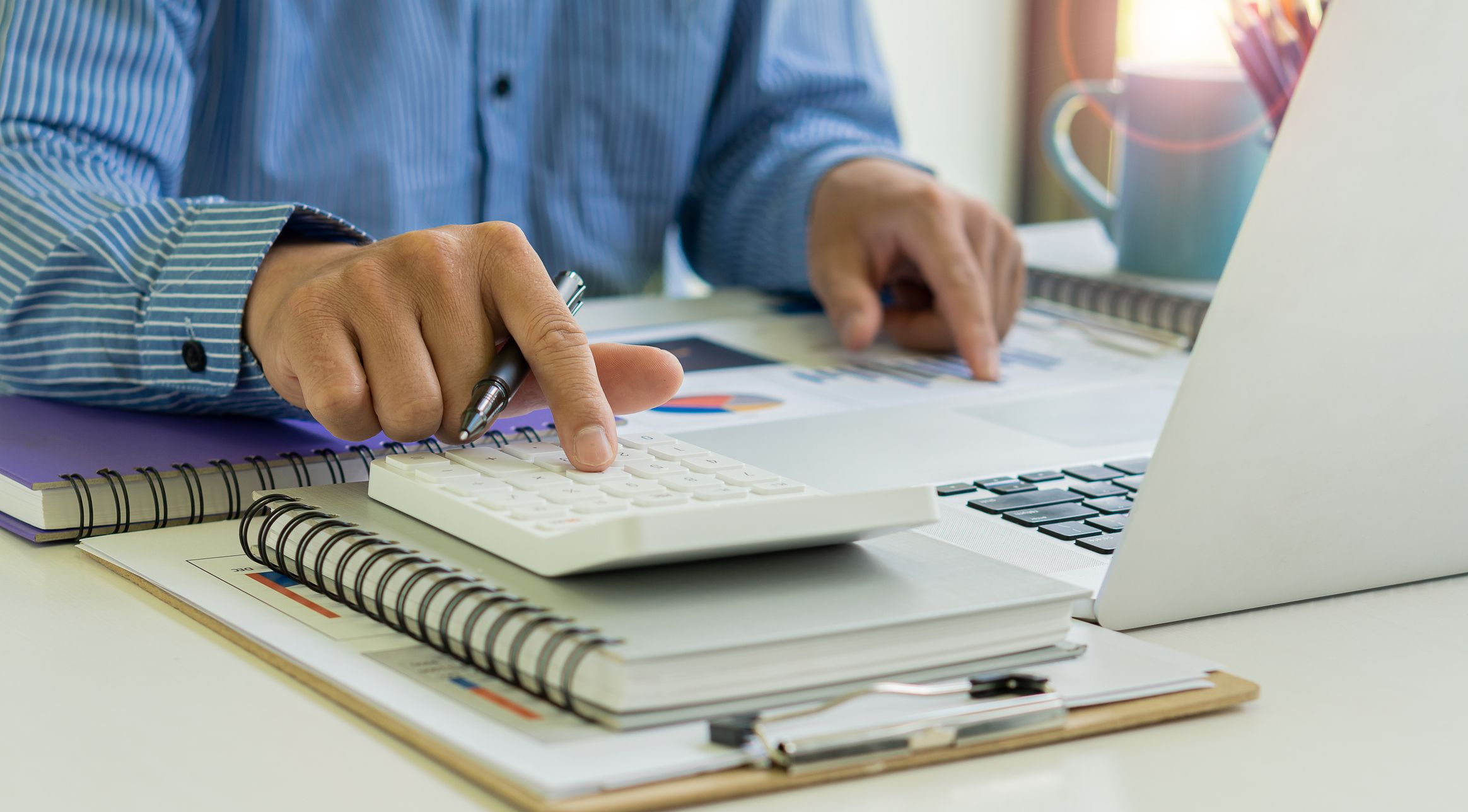 man calculating savings on electric bills